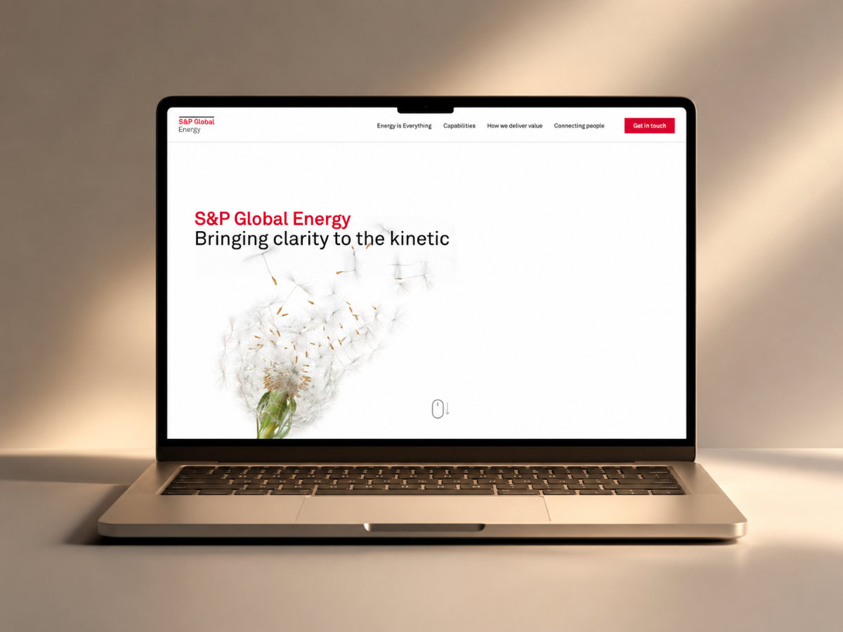 A laptop displaying the S&P Global Energy homepage with text