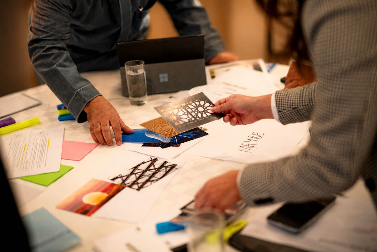 Team deciding on different design options around a table